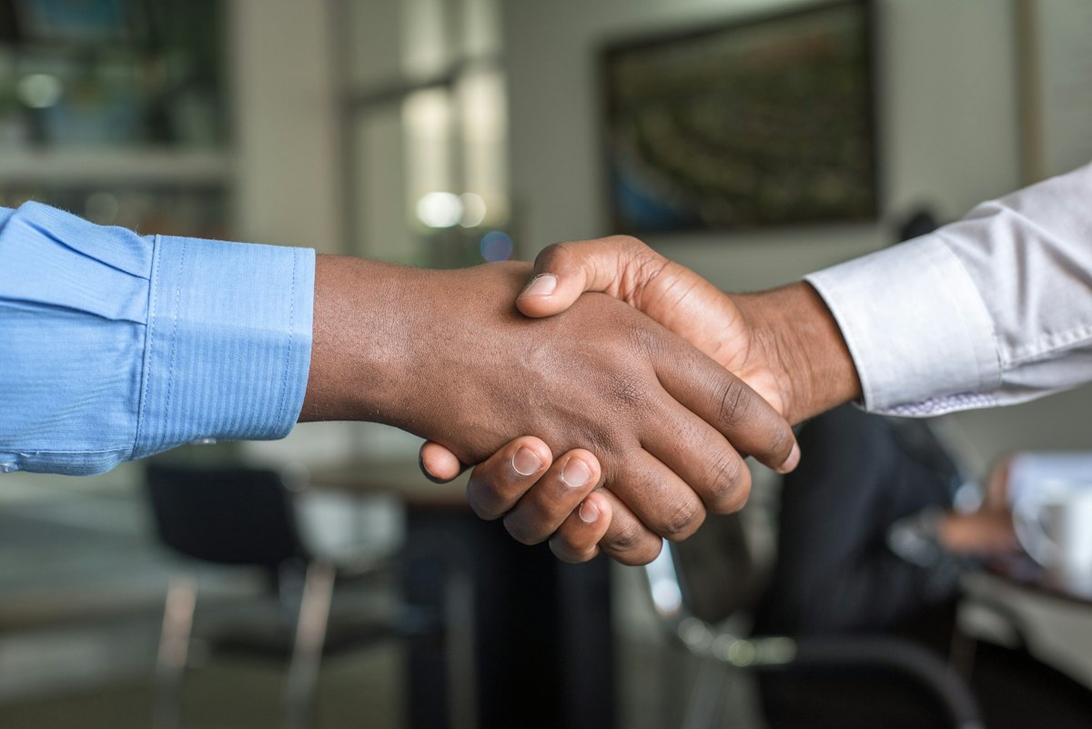 Two members agreeing with a handshake